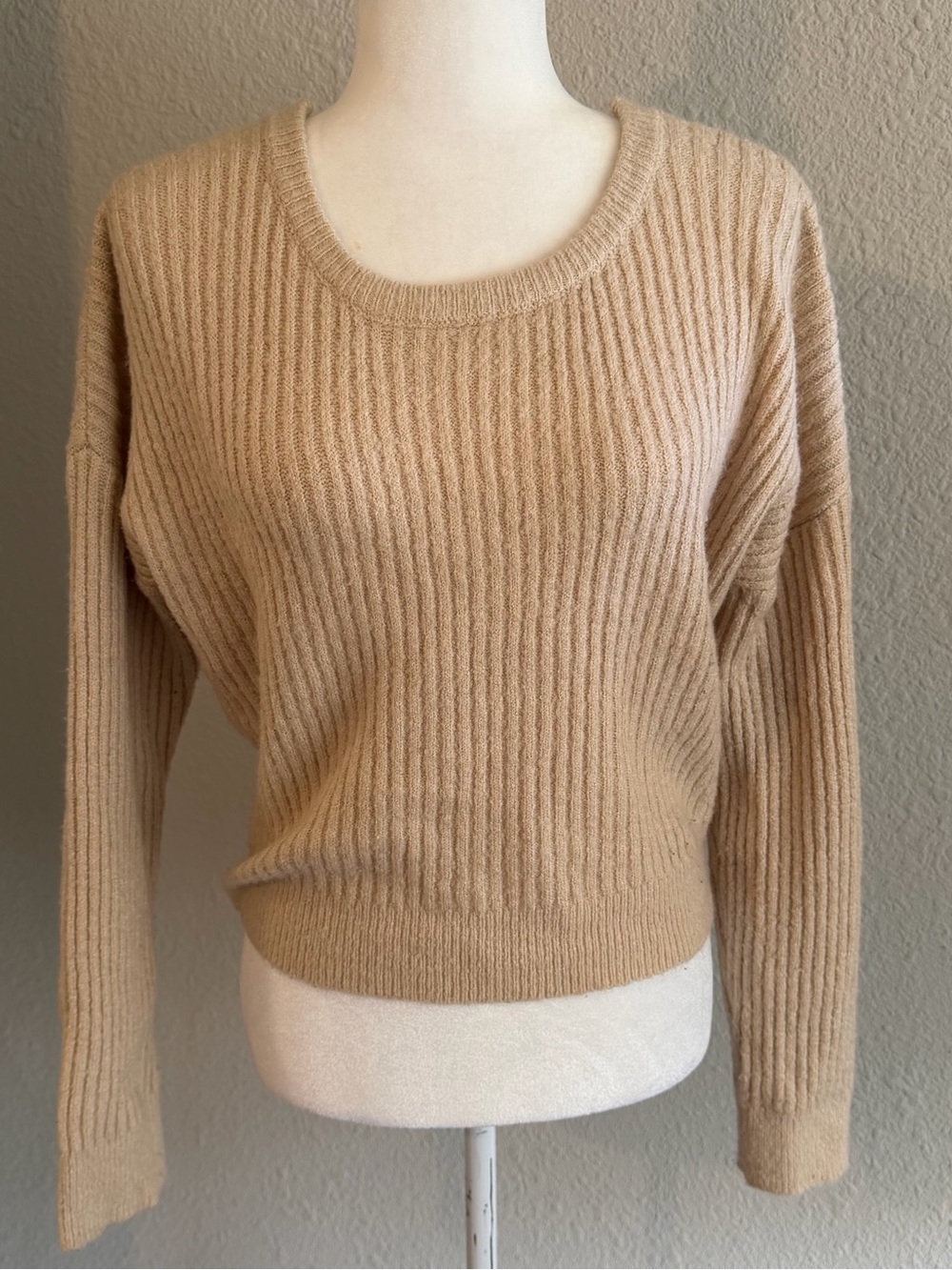 Tan ribbed knit sweater with a twist back